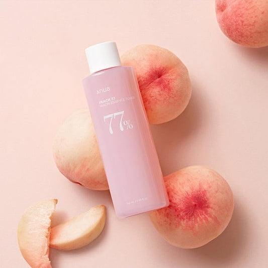 Anua Peach 77% Niacin Essence Toner bottle with peach-themed label, featuring clear liquid and white cap.