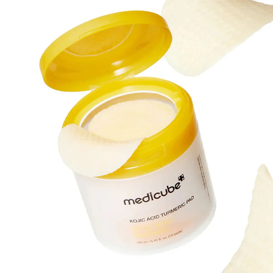 Medicube Kojic Acid Turmeric Pad showing textured surface with turmeric and Kojic Acid ingredients for brightening skin.